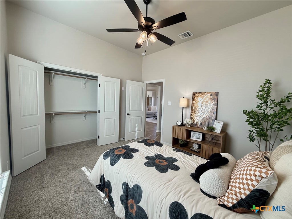 203 Lasso Loop Lorena, TX 76655 - Photo 16 of 36 a bedroom with bed and a chandelier