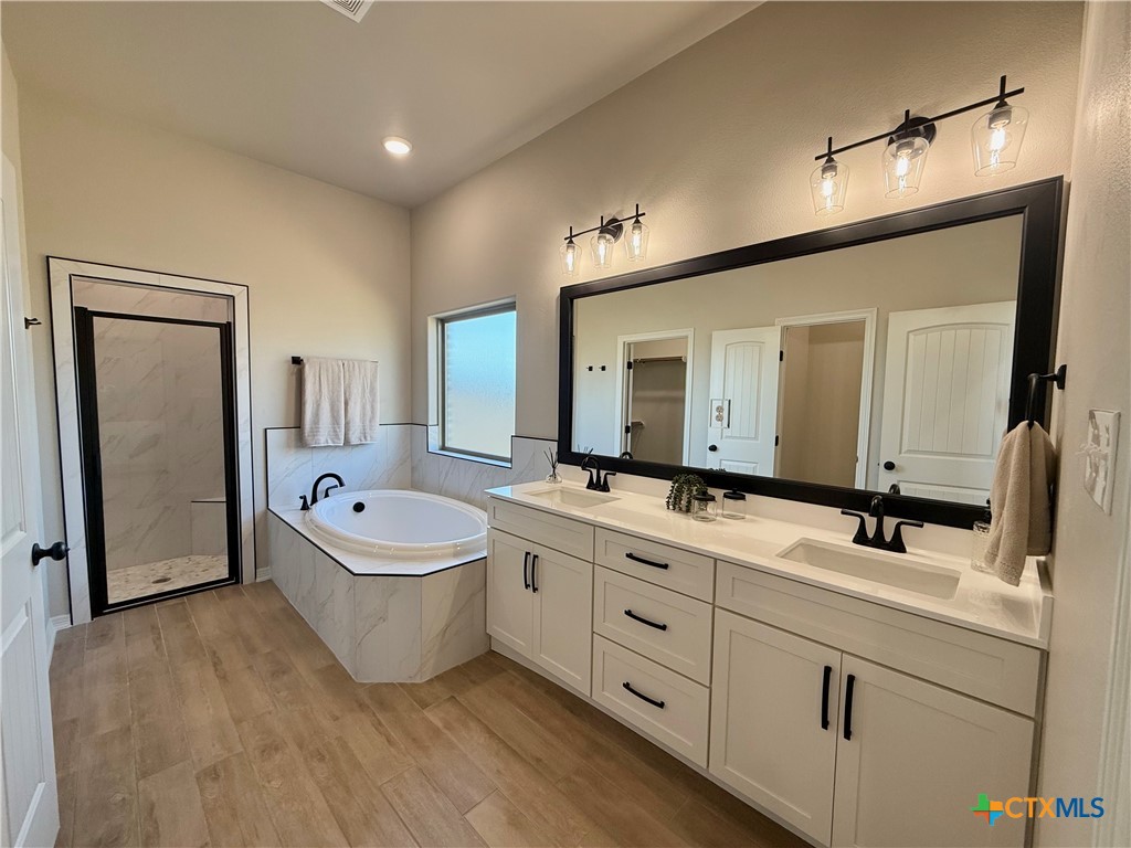 203 Lasso Loop Lorena, TX 76655 - Photo 25 of 36 a spacious bathroom with a double vanity sink mirror and bathtub