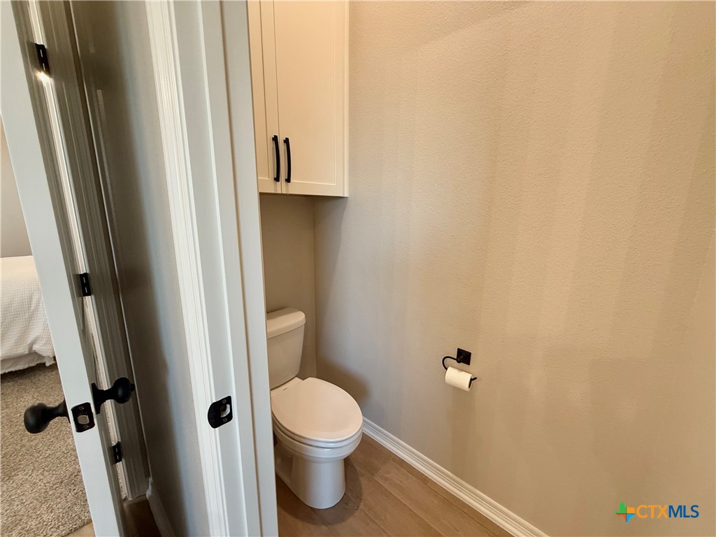 203 Lasso Loop Lorena, TX 76655 - Photo 29 of 36 a bathroom with a toilet and a shower