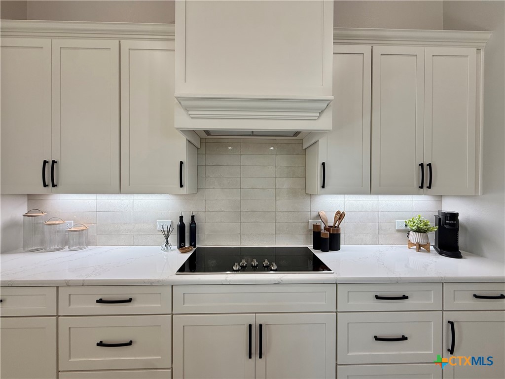 203 Lasso Loop Lorena, TX 76655 - Photo 10 of 36 a kitchen with white cabinets and white appliances