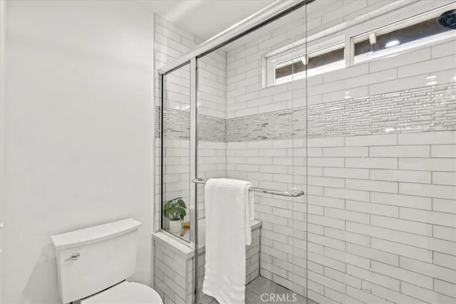 a bathroom with a toilet and shower