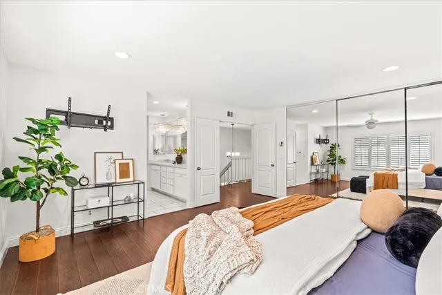 a spacious bedroom with a balcony a bed and a couch