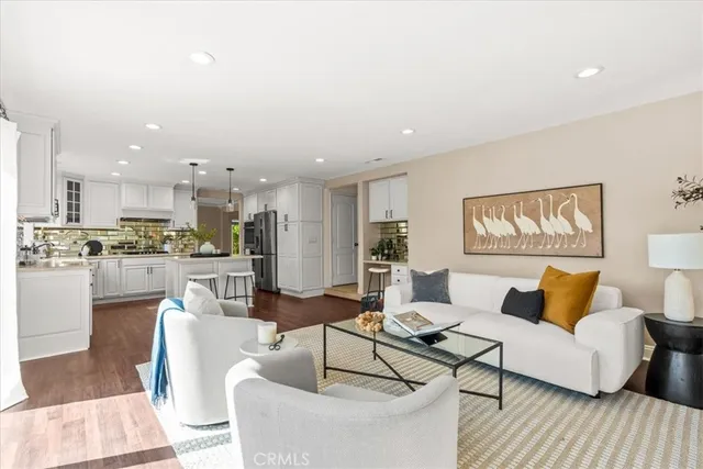 a living room with furniture and kitchen view