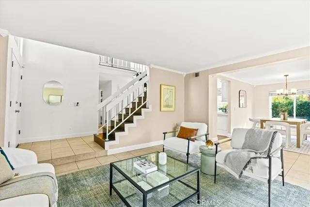 a living room with furniture and a dining table