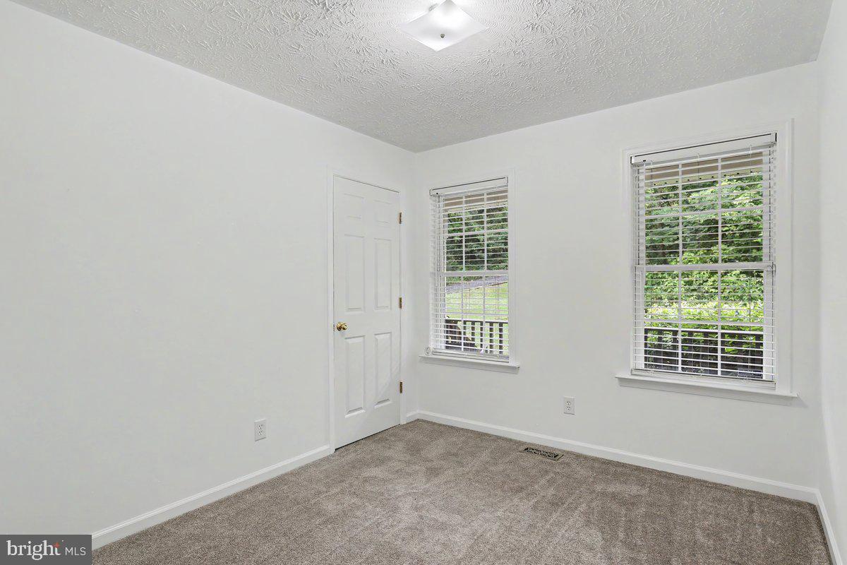 543 Whiskey Still Road Linden, VA 22642 - Photo 18 of 23 an empty room with windows