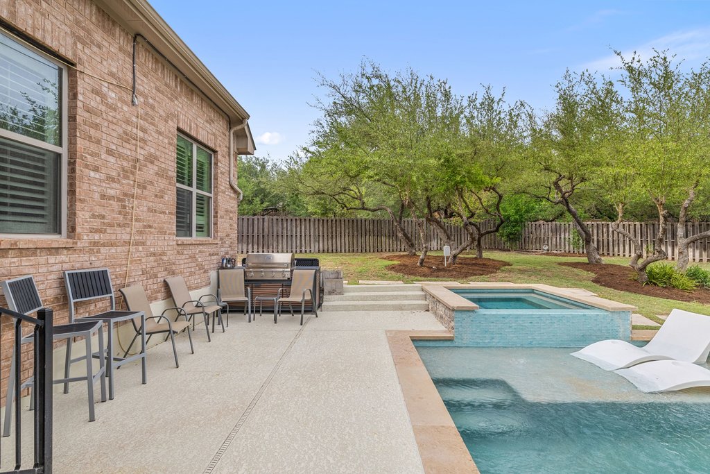 8801 Wild Rice Cove Austin, TX 78738 - Photo 36 of 40 a view of swimming pool with outdoor seating and trees in the background
