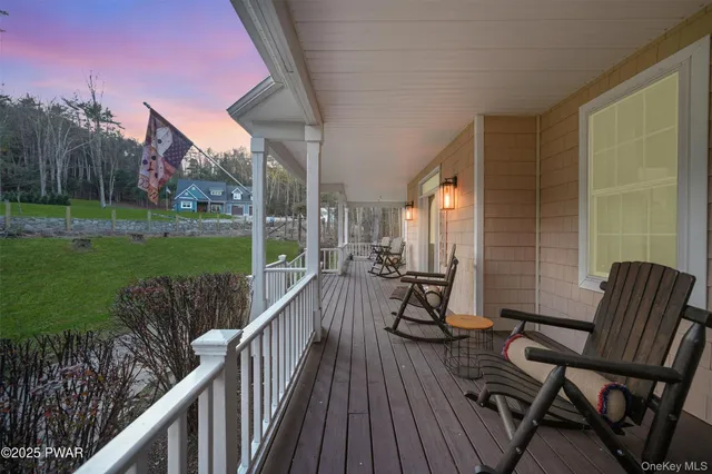 a view of a chair and table on the deck