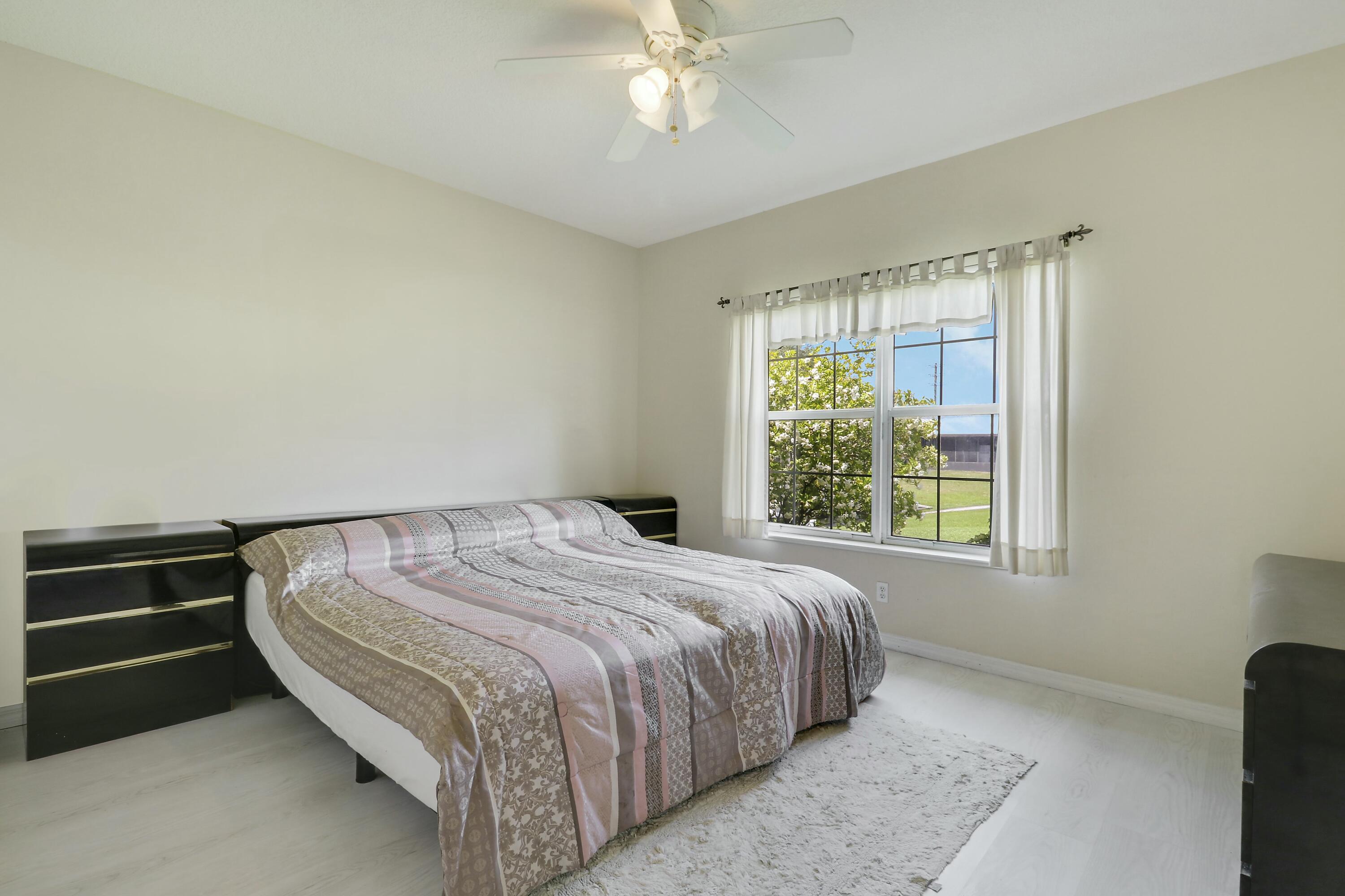 1914 Southeast 30th Street Okeechobee, FL 34974 - Photo 22 of 41 a bedroom with a bed and a window