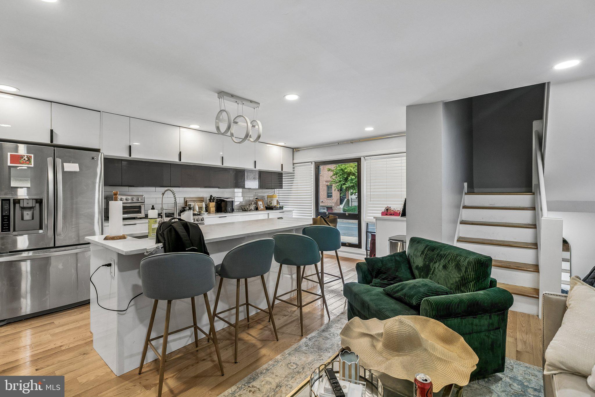 1130 Lombard Street Philadelphia, PA 19147 - Photo 6 of 45 a kitchen with stainless steel appliances kitchen island granite countertop a refrigerator and a view of living room