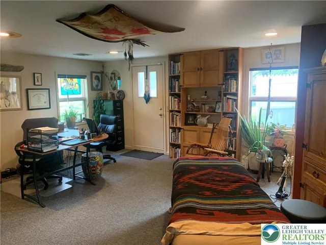 a view of a livingroom with workspace and a window