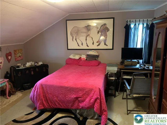 a bedroom with a bed and dresser