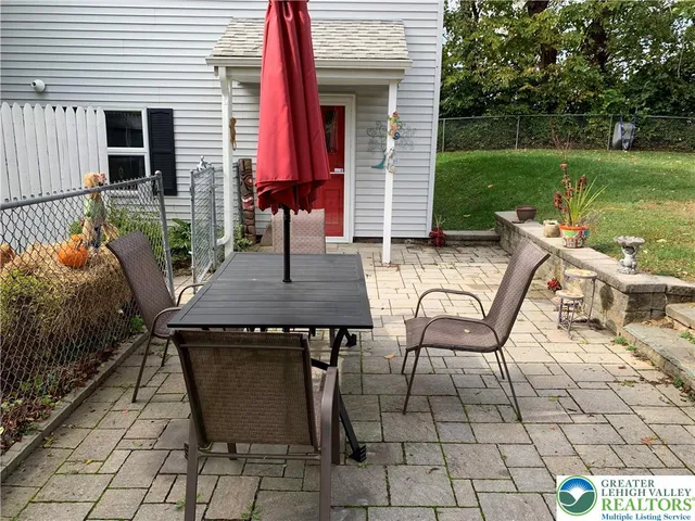 a view of a patio with couple of chairs
