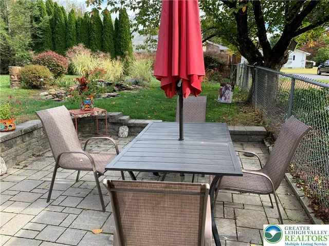 a view of a chairs and table in backyard of the house