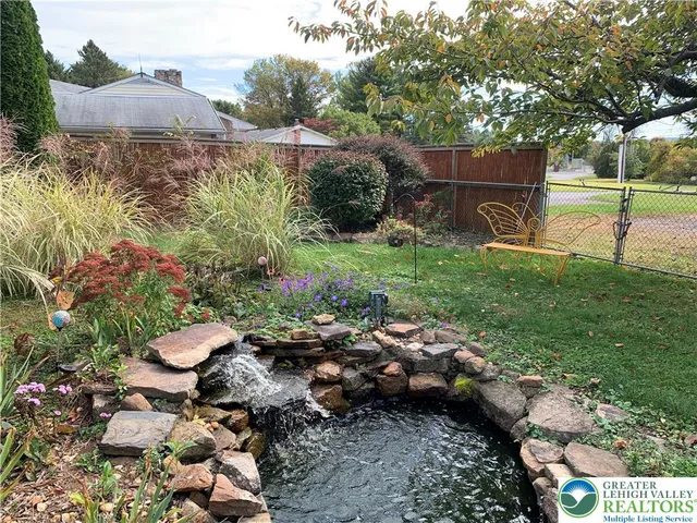 a view of a backyard with plants and a garden