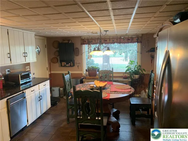 a kitchen with stainless steel appliances granite countertop a sink a stove and a refrigerator