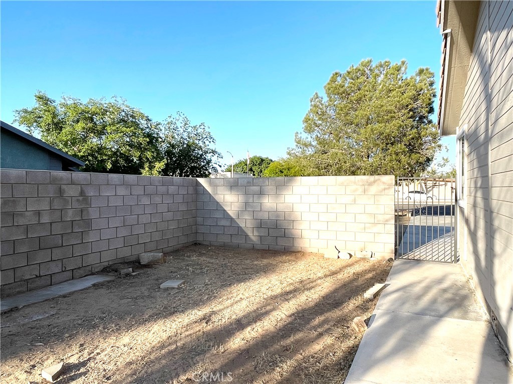12546 Navajo Road Apple Valley, CA 92308 - Photo 14 of 27 Block wall fencing encompasses the entire rear yard.