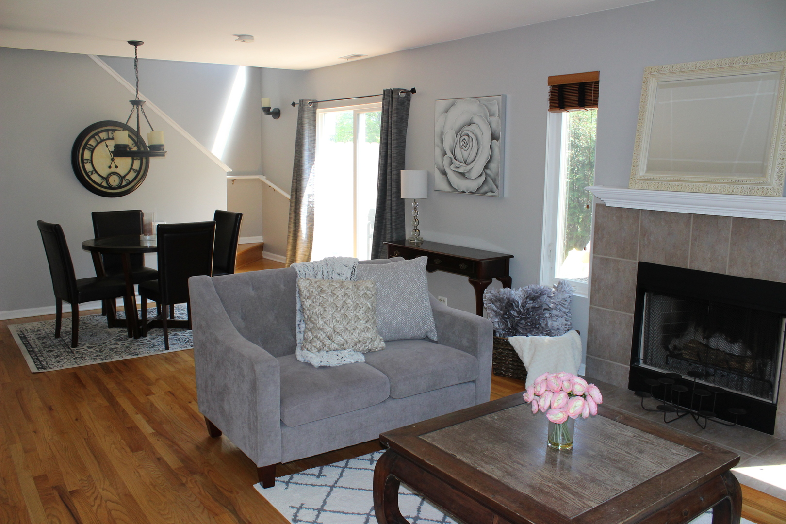 481 River Bend Road, Unit 107 Naperville, IL 60540 - Photo 2 of 17 a living room with furniture a clock and a fireplace