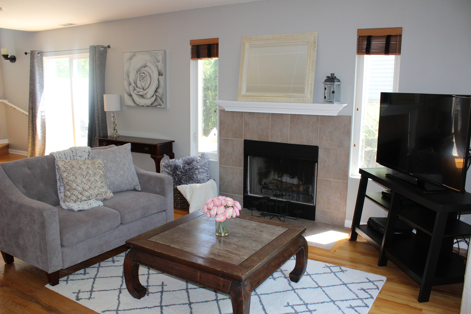 481 River Bend Road, Unit 107 Naperville, IL 60540 - Photo 12 of 17 a living room with furniture a flat screen tv and a fireplace