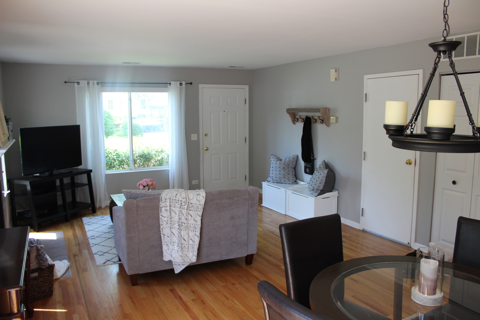 481 River Bend Road, Unit 107 Naperville, IL 60540 - Photo 13 of 17 a living room with furniture and a flat screen tv
