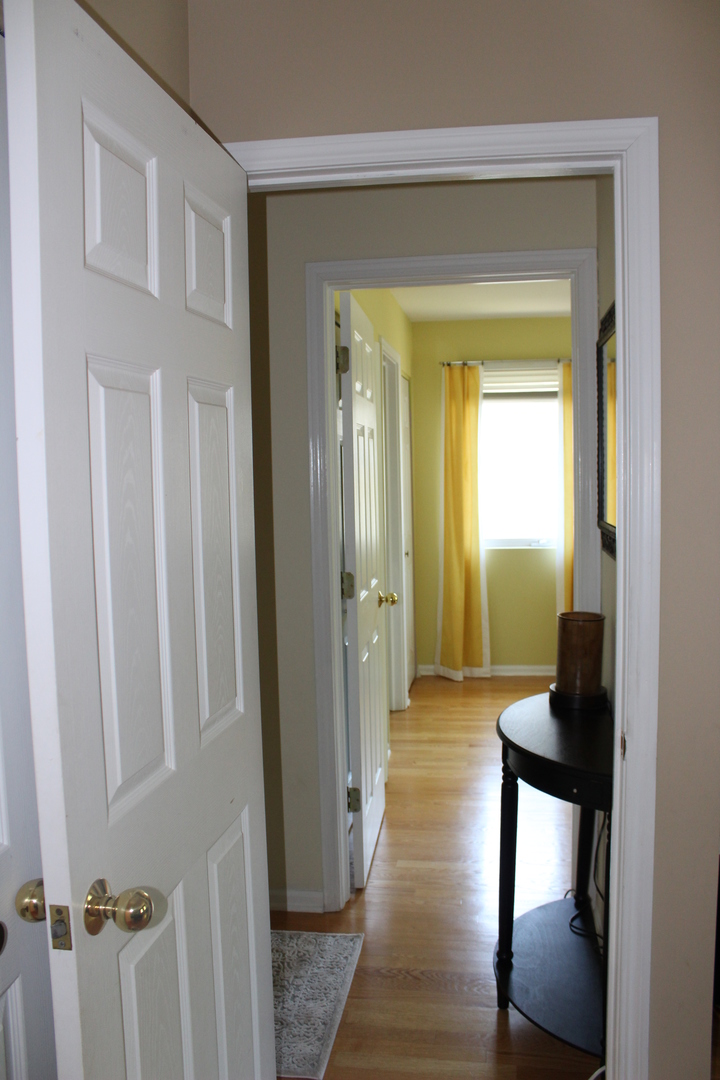 481 River Bend Road, Unit 107 Naperville, IL 60540 - Photo 10 of 17 a view of a hallway and a livingroom with furniture
