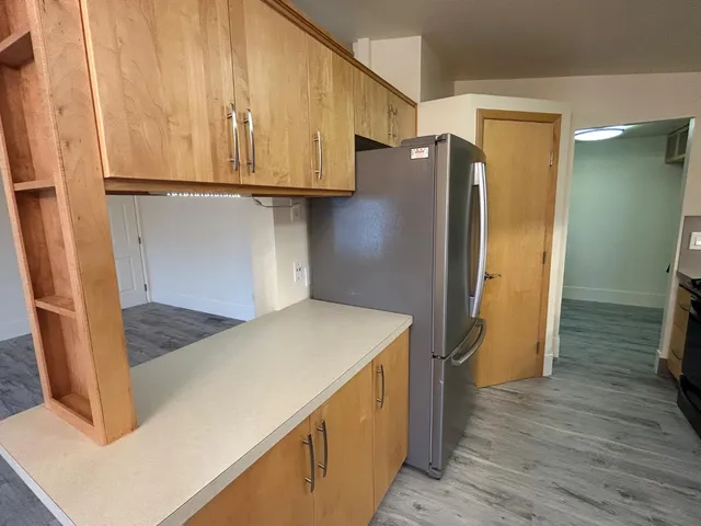 a view of entryway and hall with wooden floor