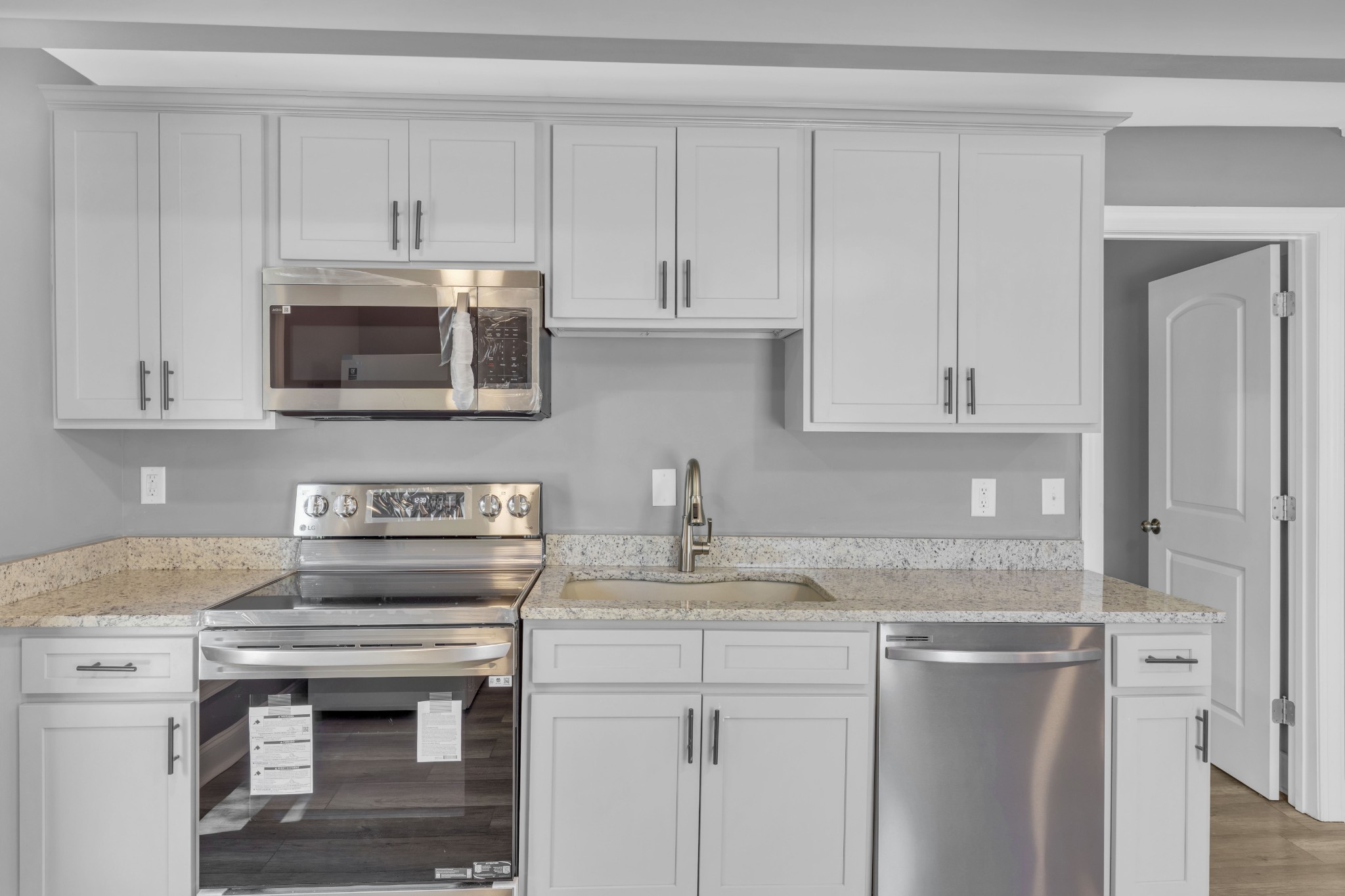 223 East 4th Avenue Springfield, TN 37172 - Photo 6 of 13 a kitchen with stainless steel appliances granite countertop a stove microwave and cabinets
