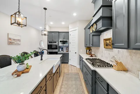 a kitchen with wooden cabinets and a stove top oven