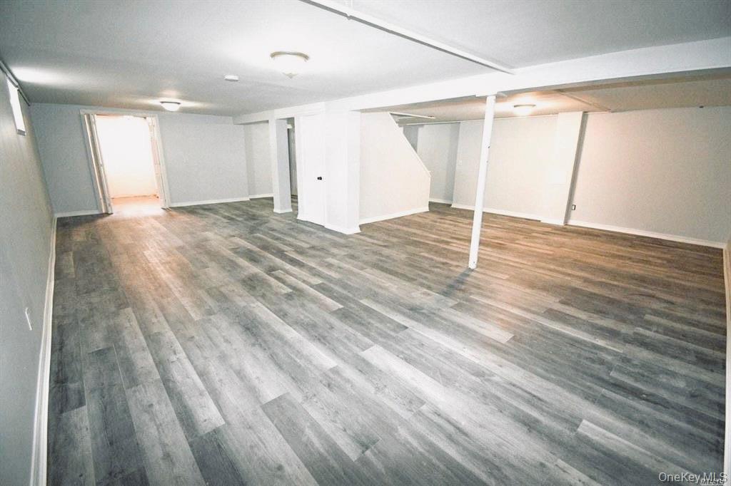 241 Woodbury Road Hicksville, NY 11801 - Photo 13 of 13 a view of empty room with wooden floor and fan