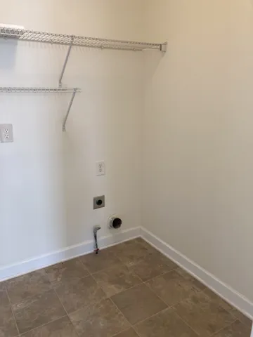 en empty room with windows and ceiling fan