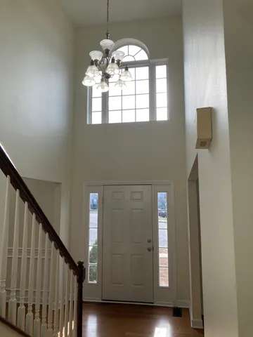 a view of staircase and kitchen with wooden floor