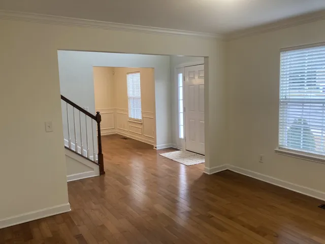 an empty room with windows and fireplace