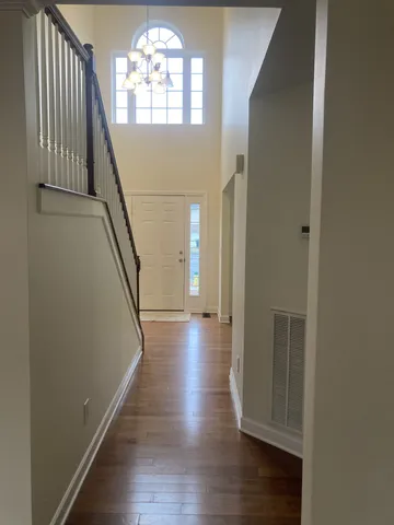 a view of an empty room with window and fireplace