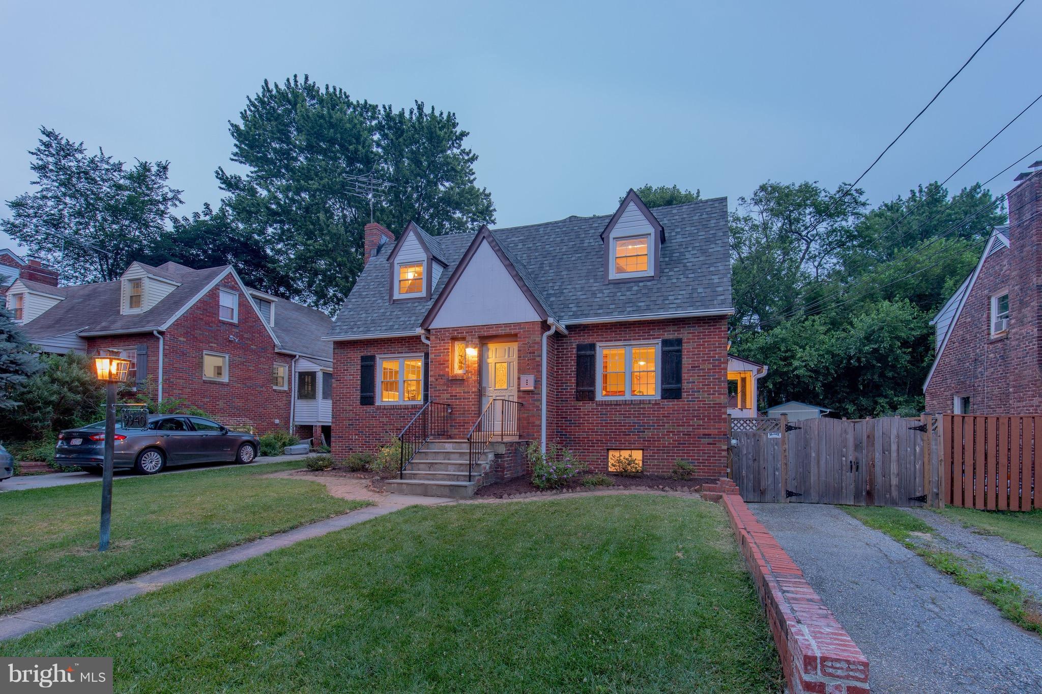 9940 Moss Avenue Silver Spring, MD 20901 - Photo 1 of 30 a front view of a house with a yard and outdoor seating