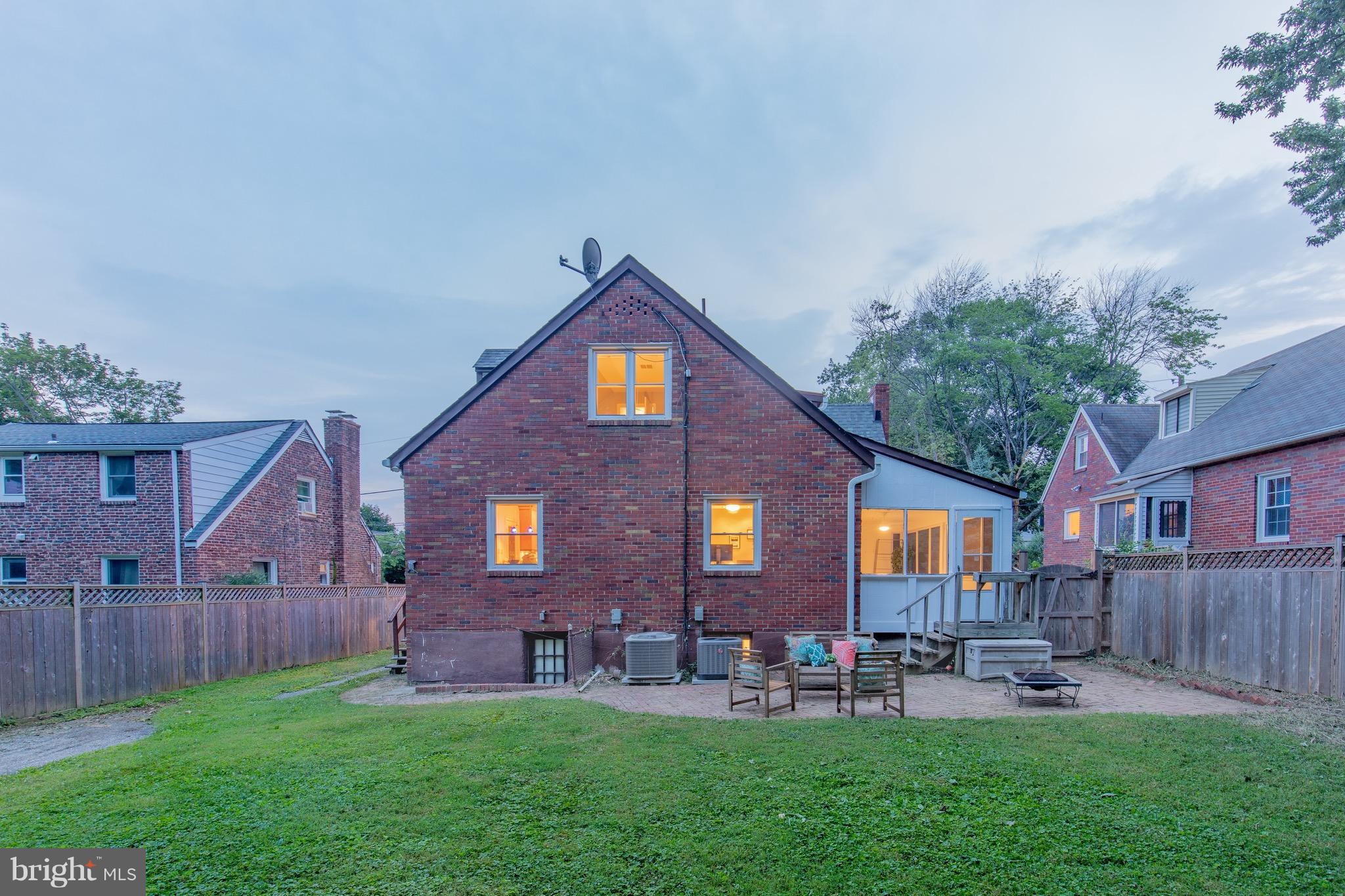 9940 Moss Avenue Silver Spring, MD 20901 - Photo 2 of 30 a front view of a house with patio and garden