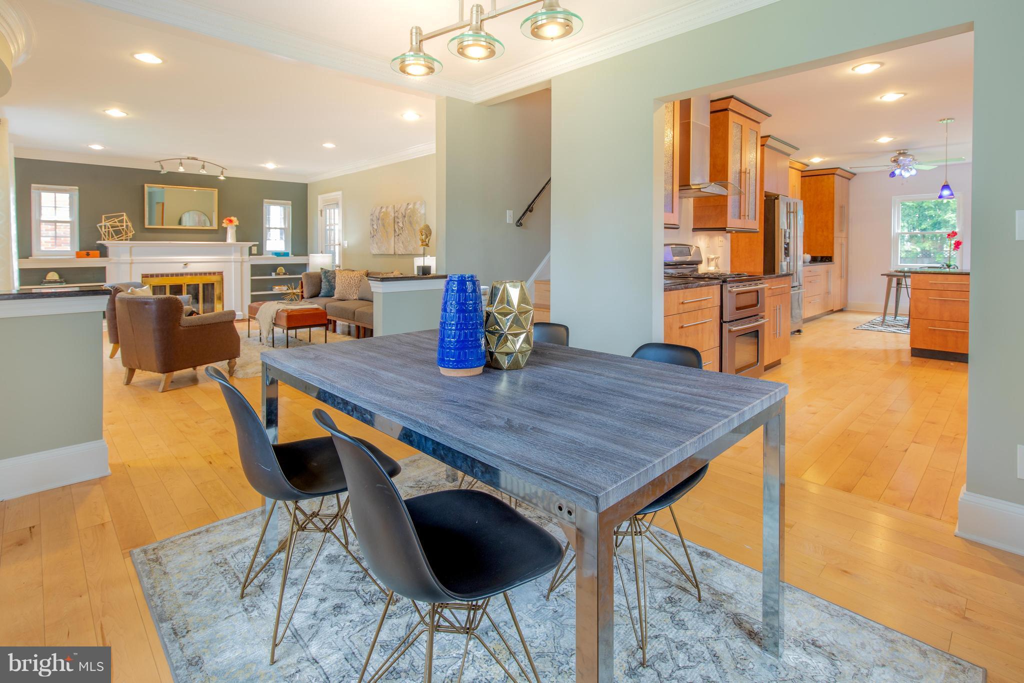 9940 Moss Avenue Silver Spring, MD 20901 - Photo 11 of 30 a dining hall with stainless steel appliances granite countertop a table chairs and a refrigerator