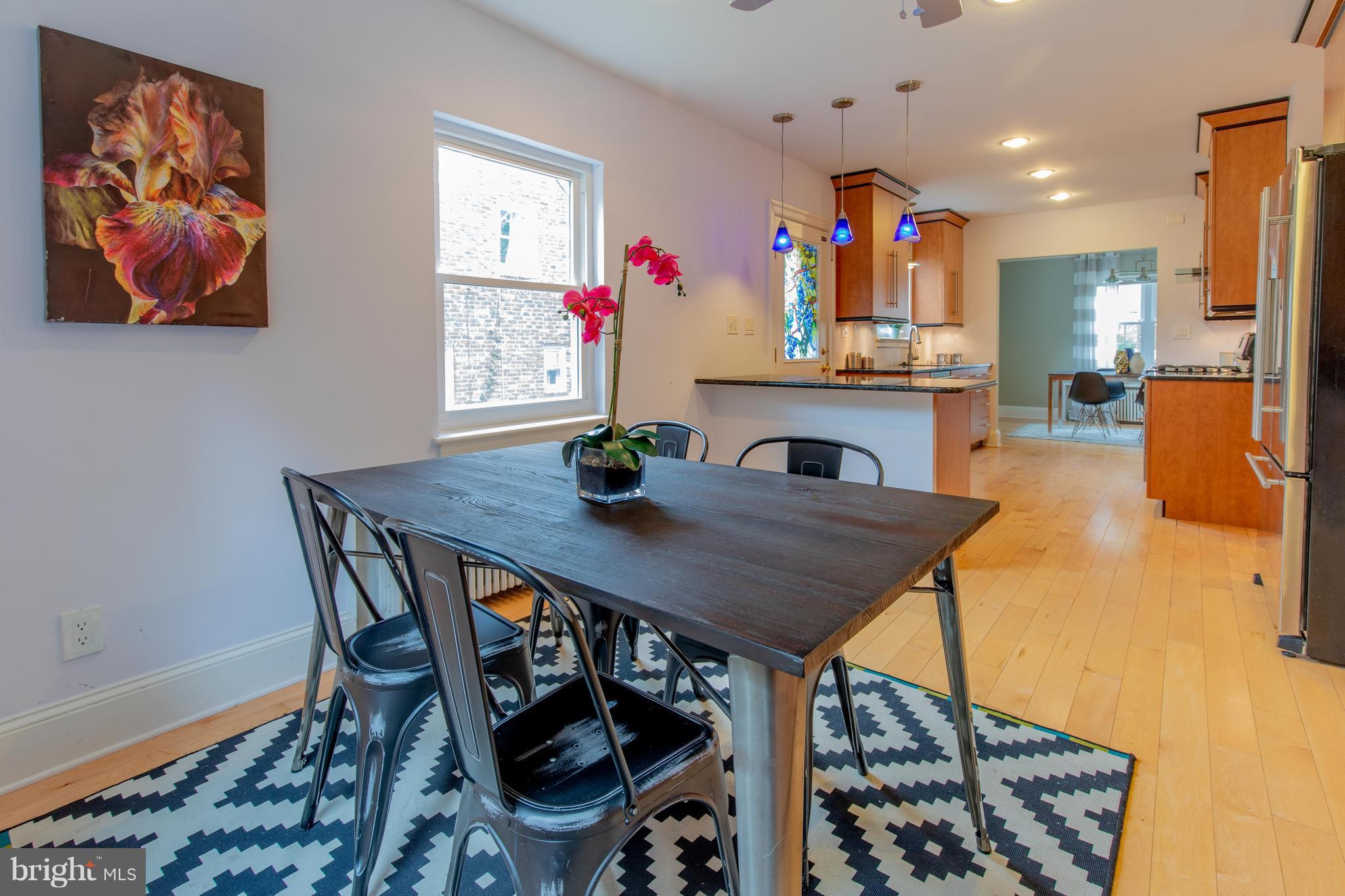 9940 Moss Avenue Silver Spring, MD 20901 - Photo 15 of 30 a view of a dining room with furniture and wooden floor