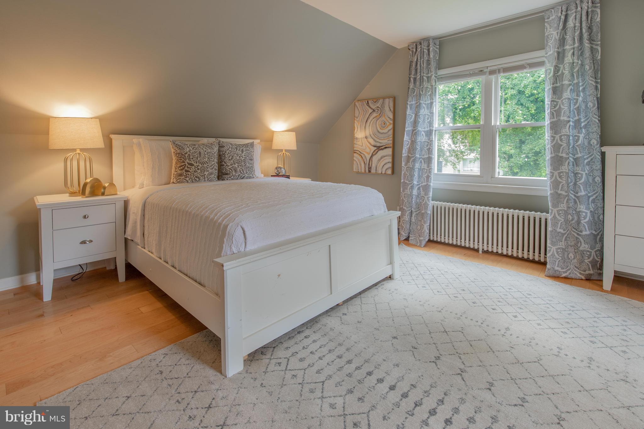 9940 Moss Avenue Silver Spring, MD 20901 - Photo 20 of 30 a spacious bedroom with a bed and a table