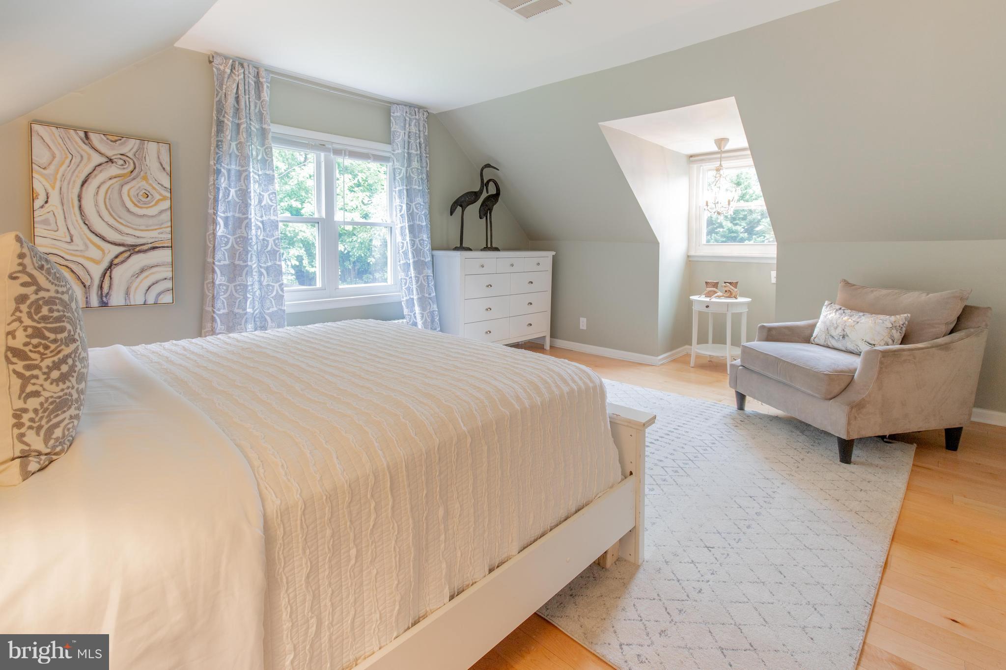 9940 Moss Avenue Silver Spring, MD 20901 - Photo 22 of 30 a spacious bedroom with a bed and a couch