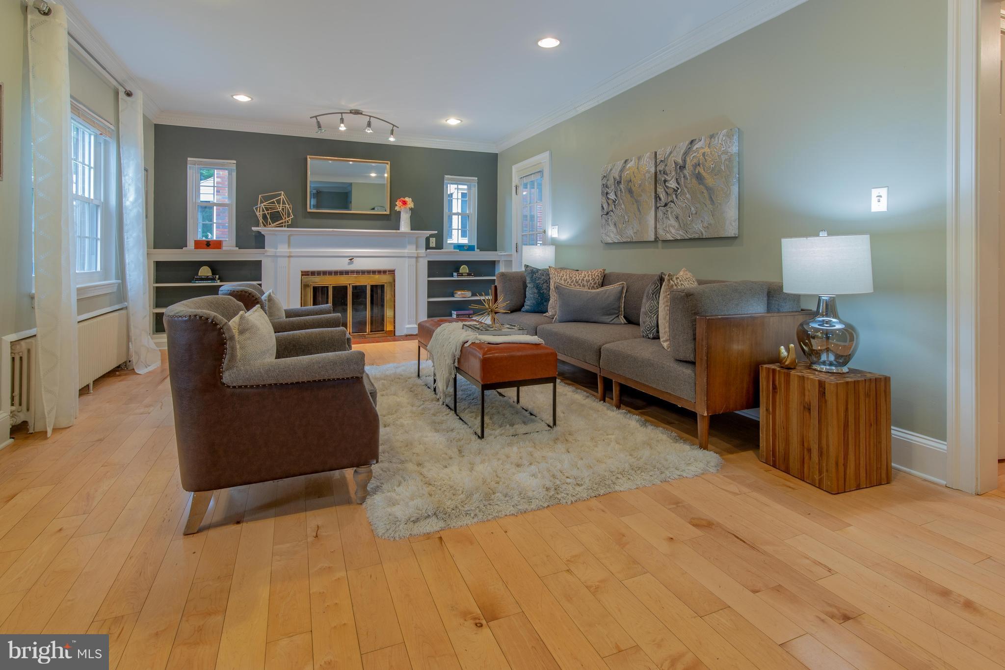 9940 Moss Avenue Silver Spring, MD 20901 - Photo 5 of 30 a living room with furniture a fireplace and a large mirror
