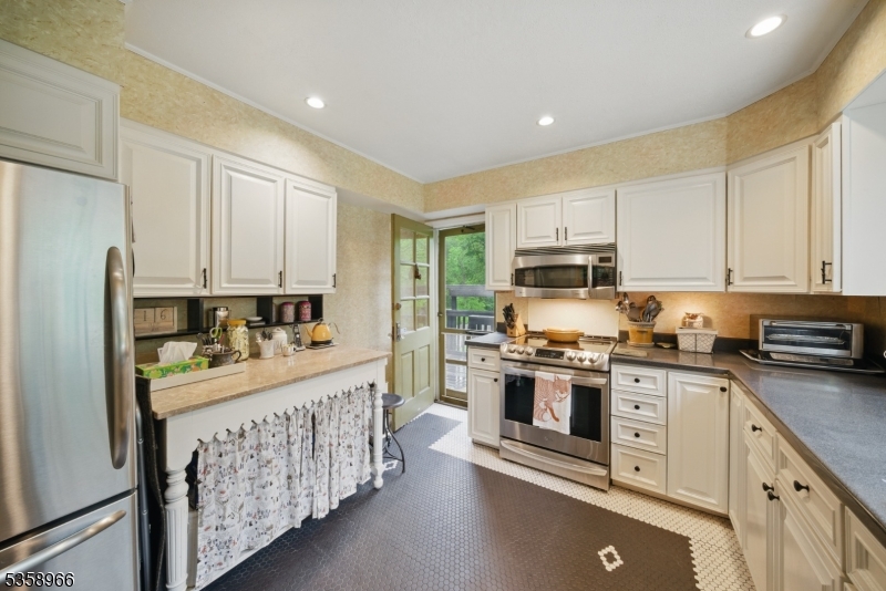 351 Franklin Road Denville, NJ 07834 - Photo 11 of 48 a kitchen with stainless steel appliances granite countertop a stove and a refrigerator