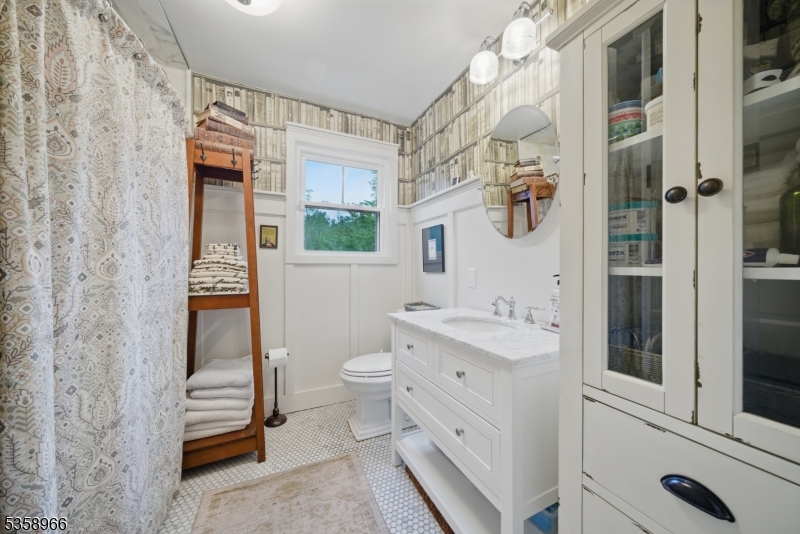 351 Franklin Road Denville, NJ 07834 - Photo 13 of 48 a bathroom with a sink a toilet and shower