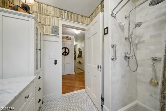 a bathroom with a shower and a sink