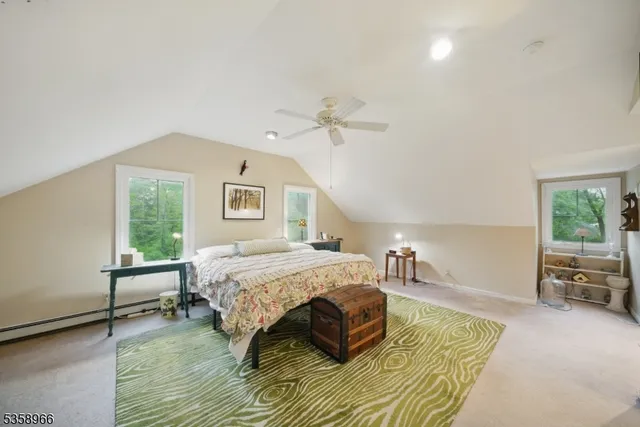 a spacious bedroom with a bed a window and couch