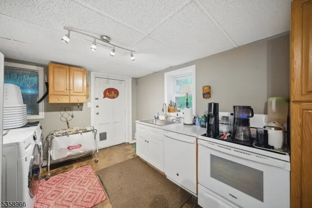 a kitchen with a sink stove and cabinets