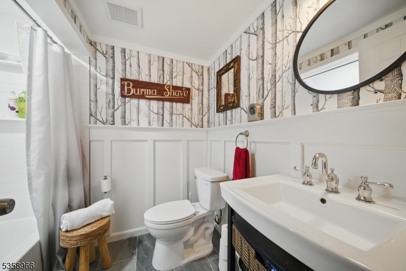 351 Franklin Road Denville, NJ 07834 - Photo 28 of 48 a bathroom with a toilet a sink and a mirror
