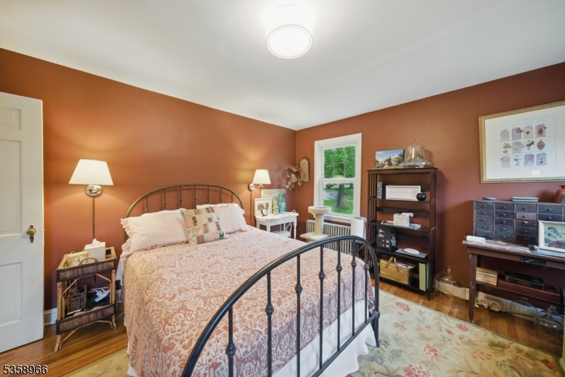 351 Franklin Road Denville, NJ 07834 - Photo 30 of 48 a bedroom with a bed and a flat tv screen on dresser