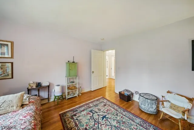 a bedroom with furniture and a rug