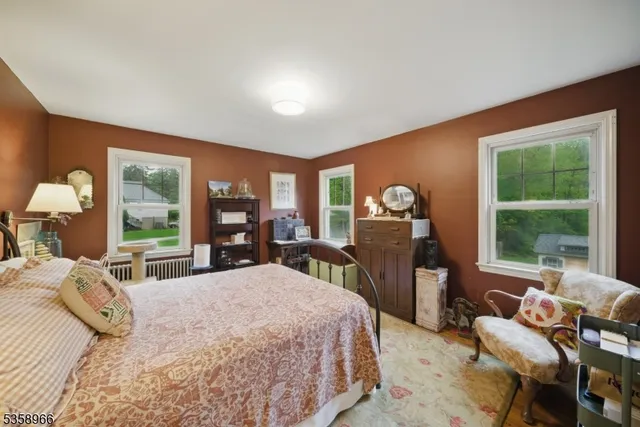 a bedroom with a large bed and a large window