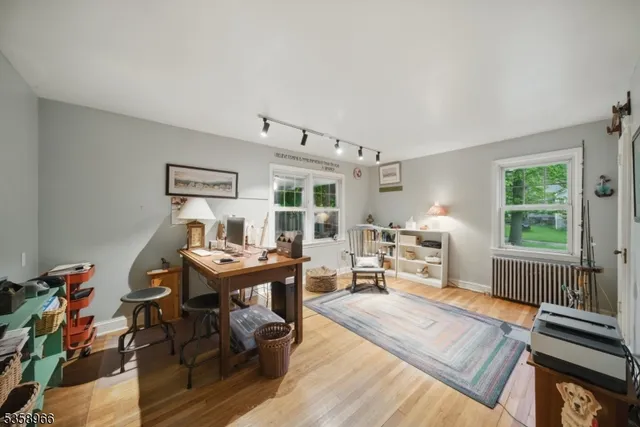 a view of a workspace with furniture and a window