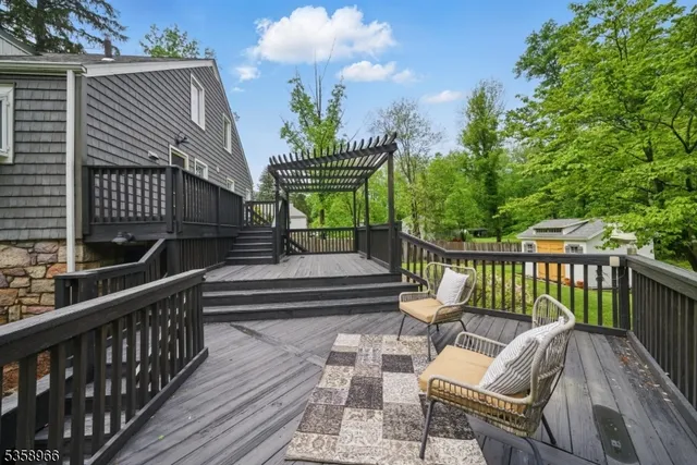 a view of balcony with wooden floor and seating space